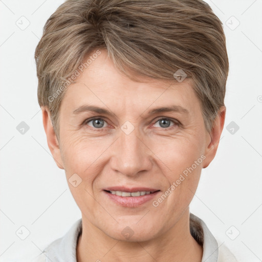 Joyful white adult female with short  brown hair and grey eyes