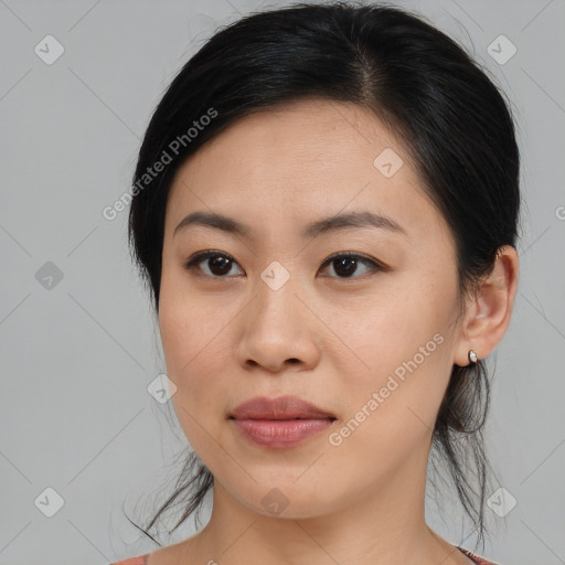 Joyful asian young-adult female with medium  brown hair and brown eyes