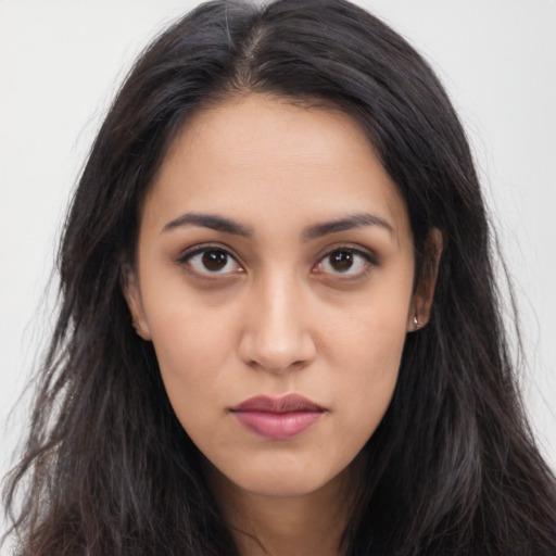 Neutral latino young-adult female with long  brown hair and brown eyes
