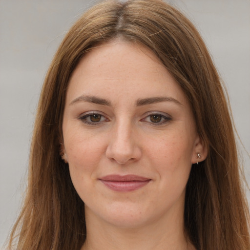 Joyful white young-adult female with long  brown hair and brown eyes