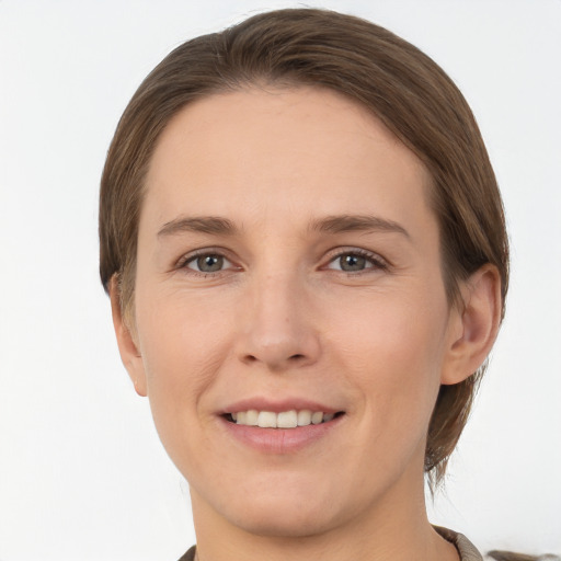 Joyful white young-adult female with short  brown hair and grey eyes