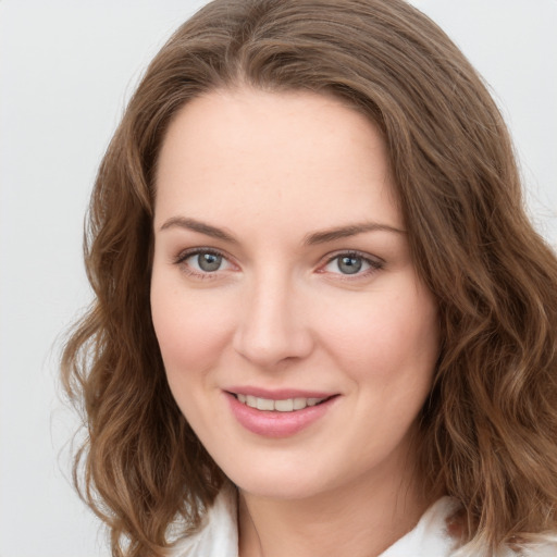 Joyful white young-adult female with long  brown hair and green eyes