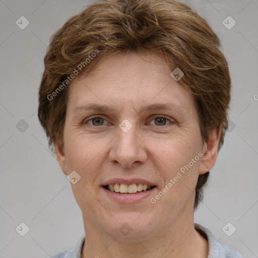 Joyful white adult female with short  brown hair and grey eyes