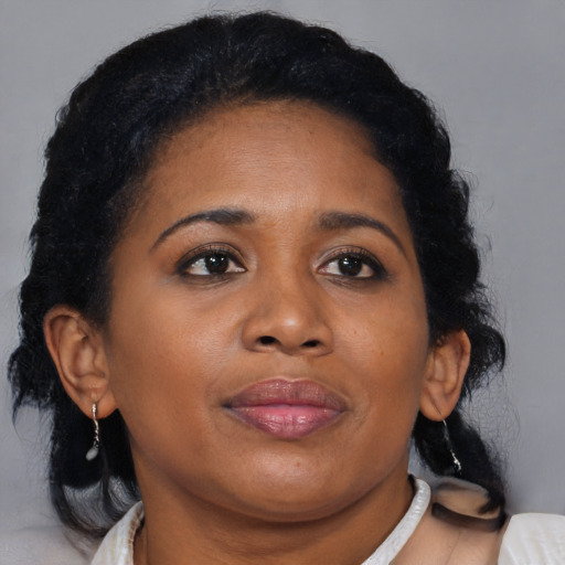 Joyful black young-adult female with medium  brown hair and brown eyes