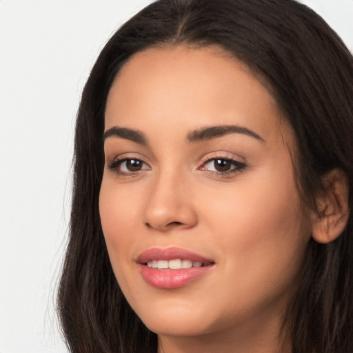 Joyful latino young-adult female with long  brown hair and brown eyes