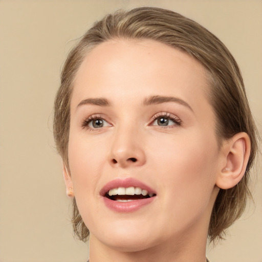 Joyful white young-adult female with medium  brown hair and grey eyes