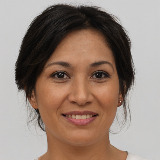 Joyful asian adult female with medium  brown hair and brown eyes