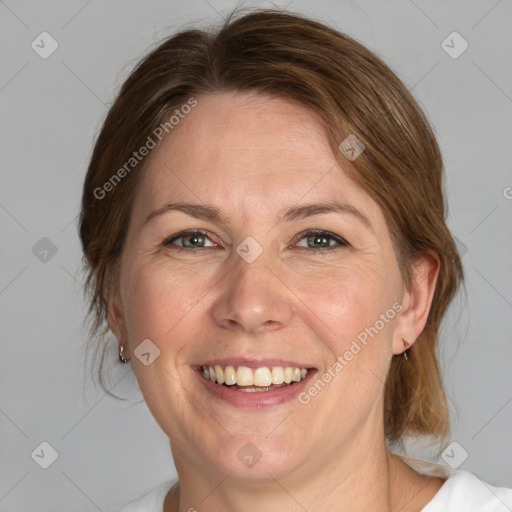 Joyful white adult female with medium  brown hair and blue eyes