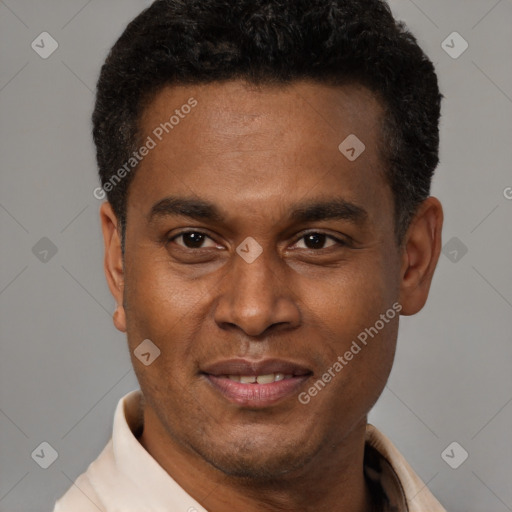 Joyful black adult male with short  black hair and brown eyes