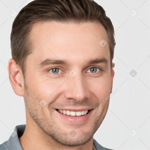 Joyful white young-adult male with short  brown hair and grey eyes