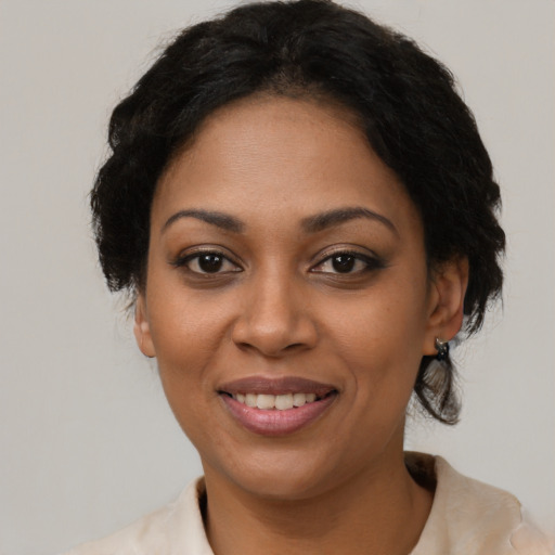Joyful black young-adult female with medium  black hair and brown eyes