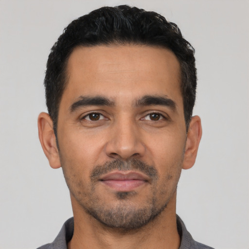 Neutral latino young-adult male with short  black hair and brown eyes