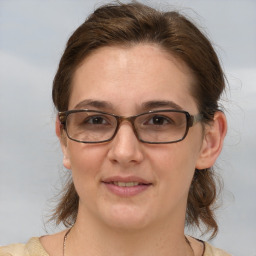 Joyful white adult female with medium  brown hair and grey eyes