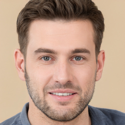 Joyful white young-adult male with short  brown hair and brown eyes