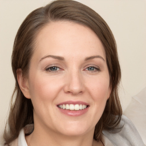 Joyful white young-adult female with medium  brown hair and grey eyes