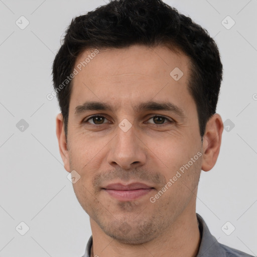 Joyful white adult male with short  black hair and brown eyes