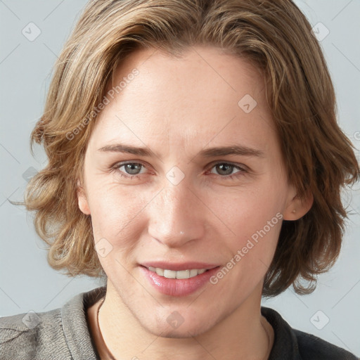 Joyful white young-adult female with medium  brown hair and blue eyes