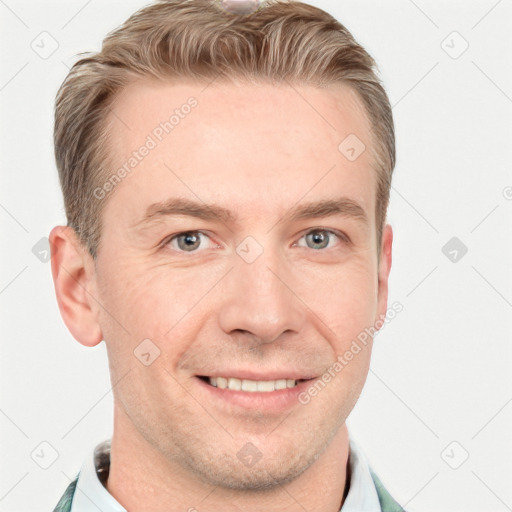 Joyful white adult male with short  brown hair and grey eyes