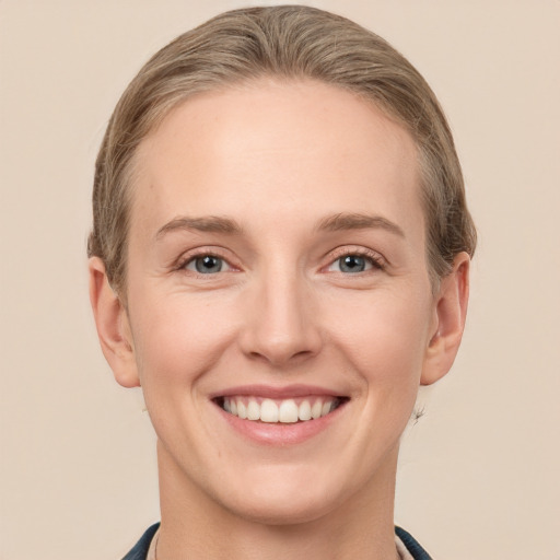 Joyful white young-adult female with short  brown hair and grey eyes