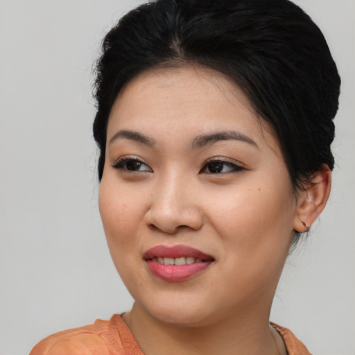 Joyful asian young-adult female with medium  brown hair and brown eyes