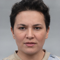 Joyful white adult female with short  brown hair and brown eyes