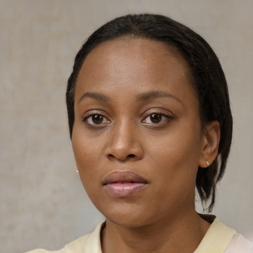 Neutral black young-adult female with medium  brown hair and brown eyes