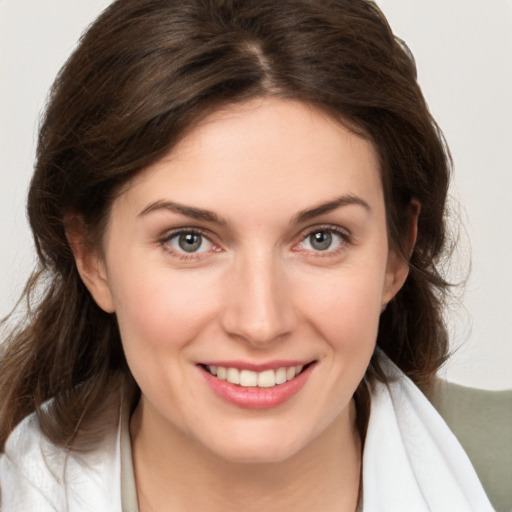 Joyful white young-adult female with medium  brown hair and grey eyes