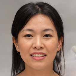 Joyful asian young-adult female with medium  brown hair and brown eyes