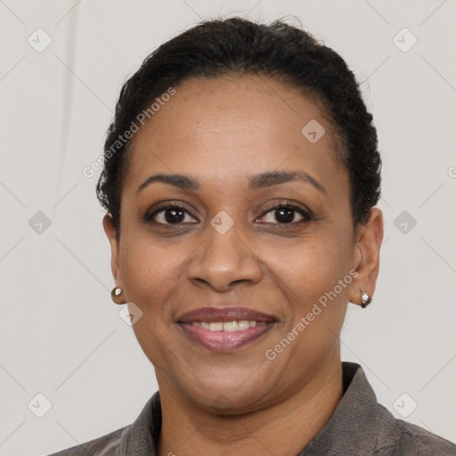 Joyful black adult female with short  brown hair and brown eyes