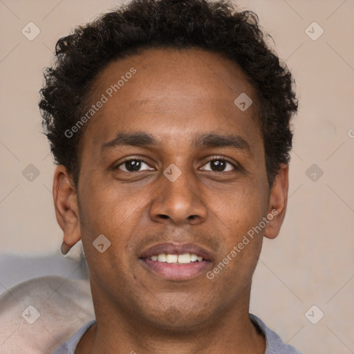 Joyful latino young-adult male with short  brown hair and brown eyes