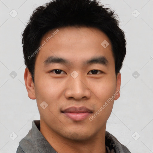 Joyful asian young-adult male with short  black hair and brown eyes