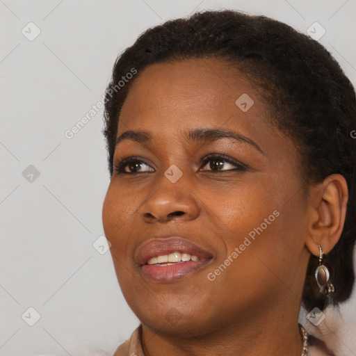 Joyful black young-adult female with short  brown hair and brown eyes