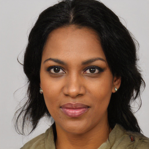 Joyful black young-adult female with medium  brown hair and brown eyes