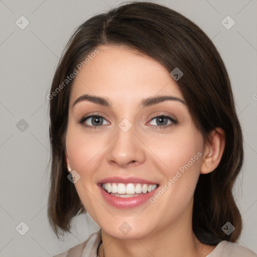 Joyful white young-adult female with medium  brown hair and green eyes