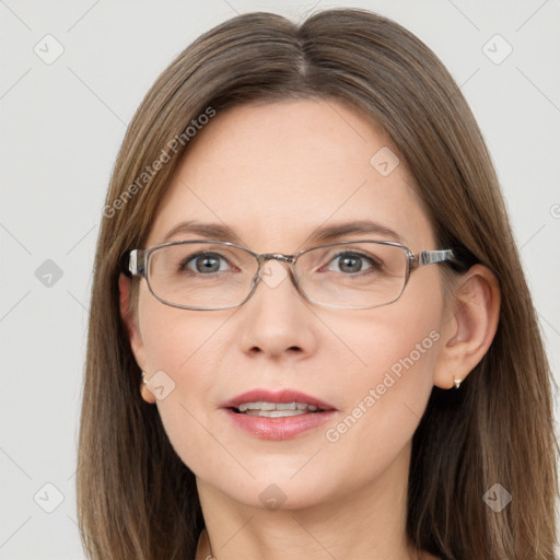 Joyful white adult female with long  brown hair and blue eyes