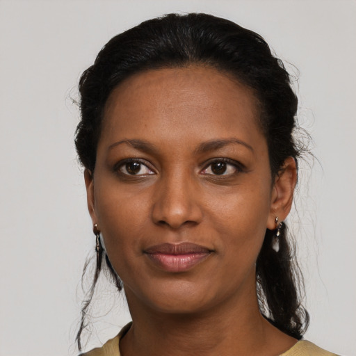 Joyful black young-adult female with medium  black hair and brown eyes