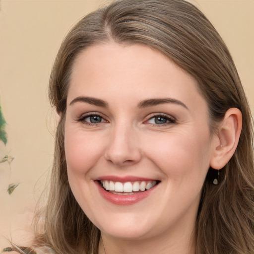 Joyful white young-adult female with long  brown hair and grey eyes