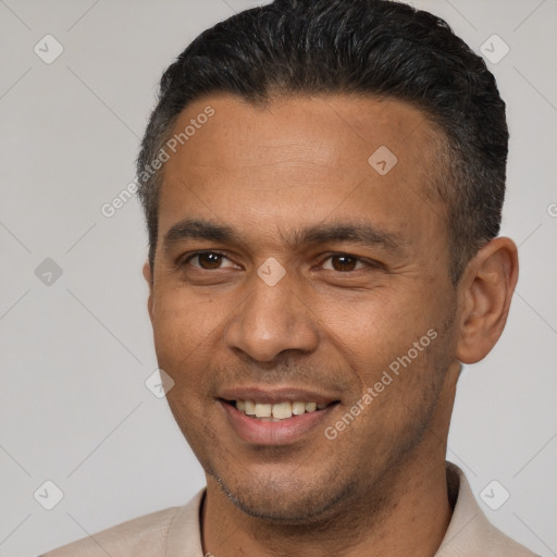 Joyful latino adult male with short  brown hair and brown eyes
