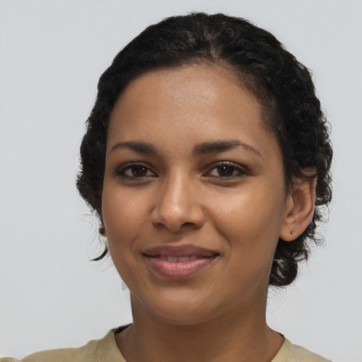 Joyful latino young-adult female with short  black hair and brown eyes