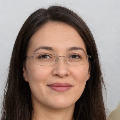 Joyful white adult female with long  brown hair and brown eyes