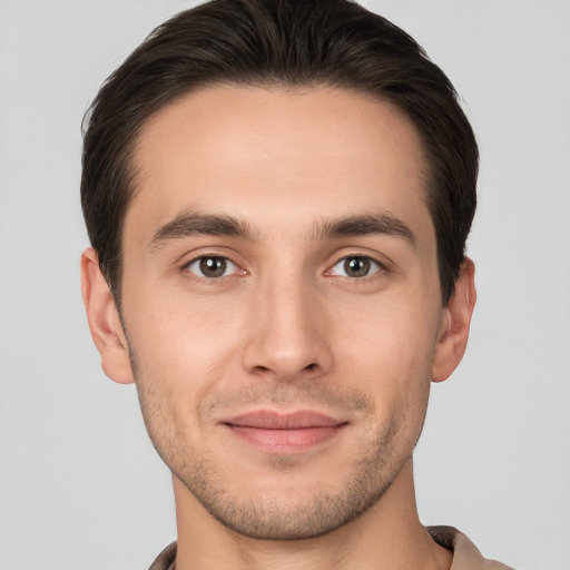 Joyful white young-adult male with short  brown hair and brown eyes