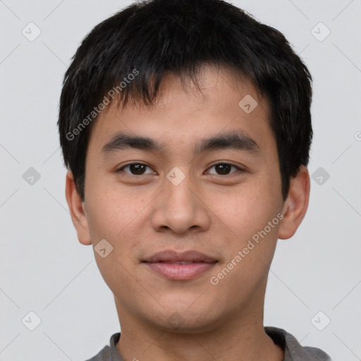 Joyful asian young-adult male with short  brown hair and brown eyes