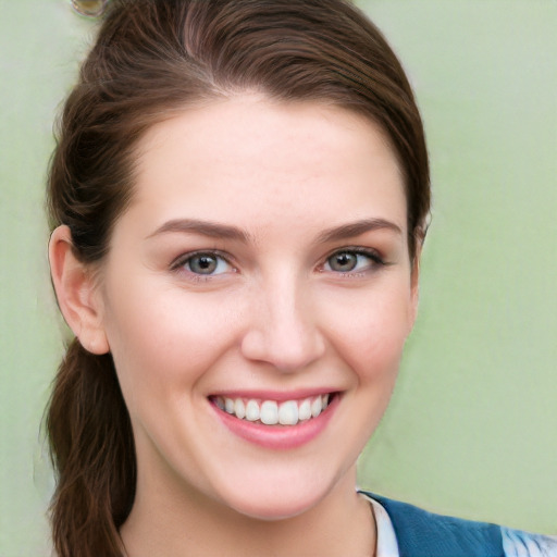 Joyful white young-adult female with long  brown hair and blue eyes