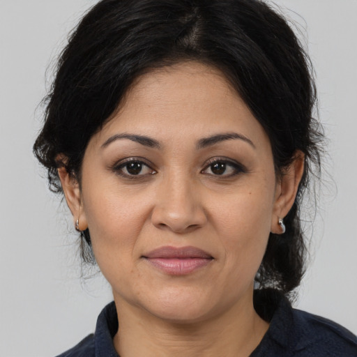 Joyful white adult female with medium  brown hair and brown eyes