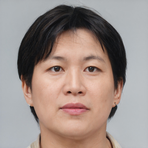 Neutral asian adult female with medium  brown hair and brown eyes