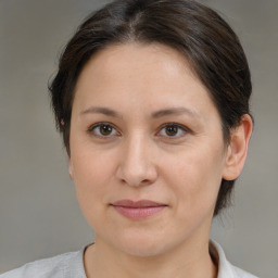 Joyful white young-adult female with medium  brown hair and brown eyes