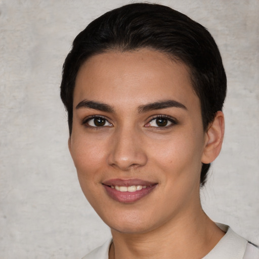 Joyful white young-adult female with short  black hair and brown eyes