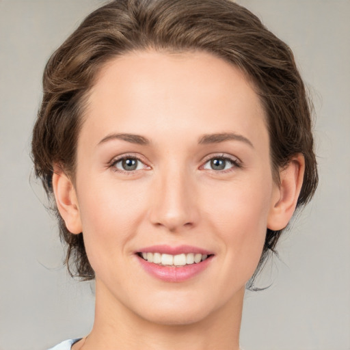 Joyful white young-adult female with medium  brown hair and green eyes