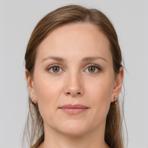 Joyful white young-adult female with medium  brown hair and grey eyes