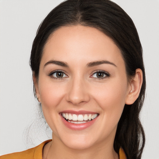 Joyful white young-adult female with long  brown hair and brown eyes